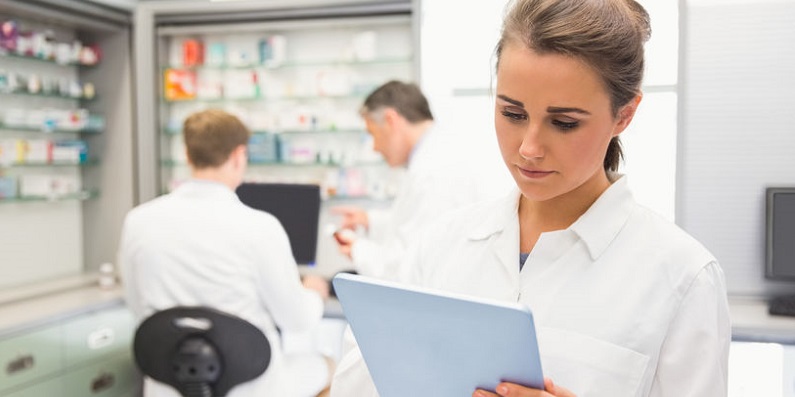 Physician Using Tablet at Hospital Pharmacy