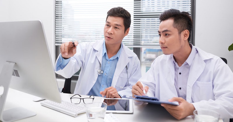 Physicians Reviewing Data Analytics Dashboard